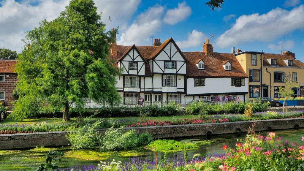 Greyfriars Gardens in Canterbury, with some old buildings on the other side of a river
